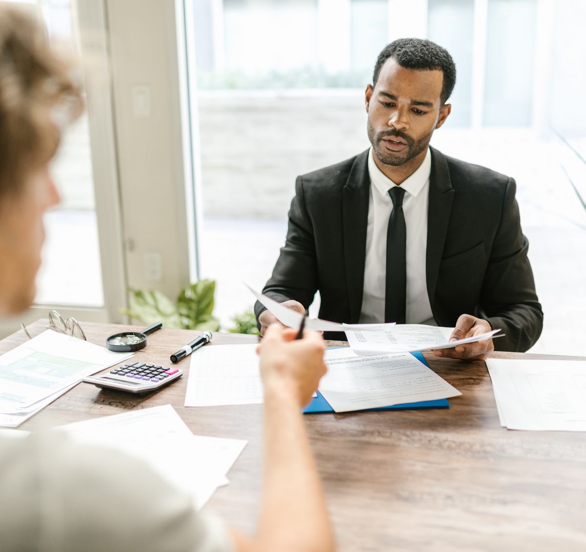 Accountant going through figures with a client across a desk