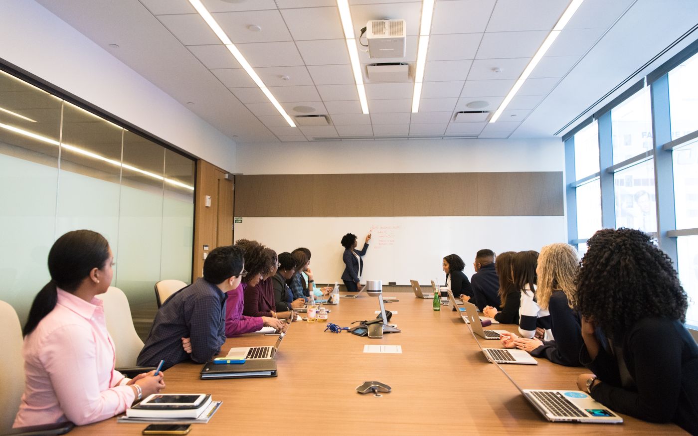 Company meeting in progress around a long boardroom table